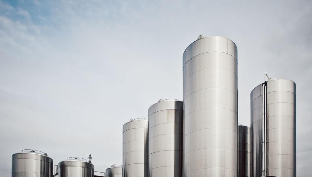 Industrial storage tanks at a green hydrogen production facility under development in Teesside by Protium.