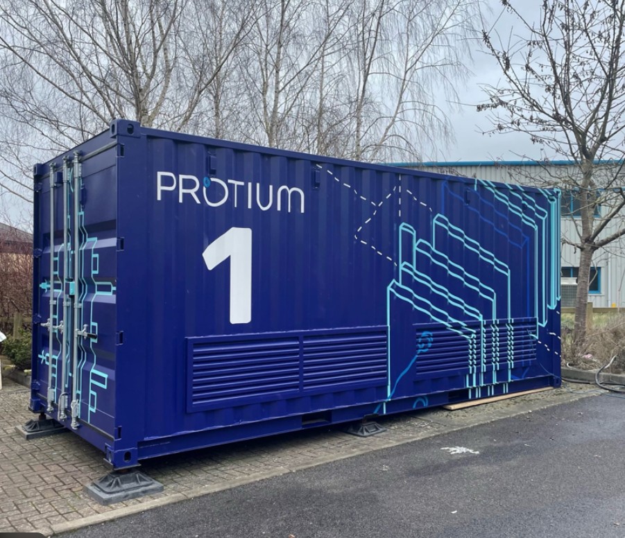 Protium 1 container with blue exterior and white branding, displaying company logo and circuit-pattern design on the side.